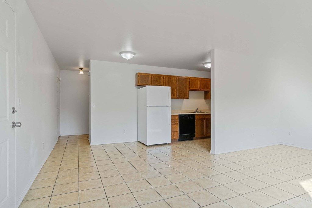 a kitchen with a white refrigerator freezer next to a black dishwasher at ReNew Eagle River, Eagle River, Alaska