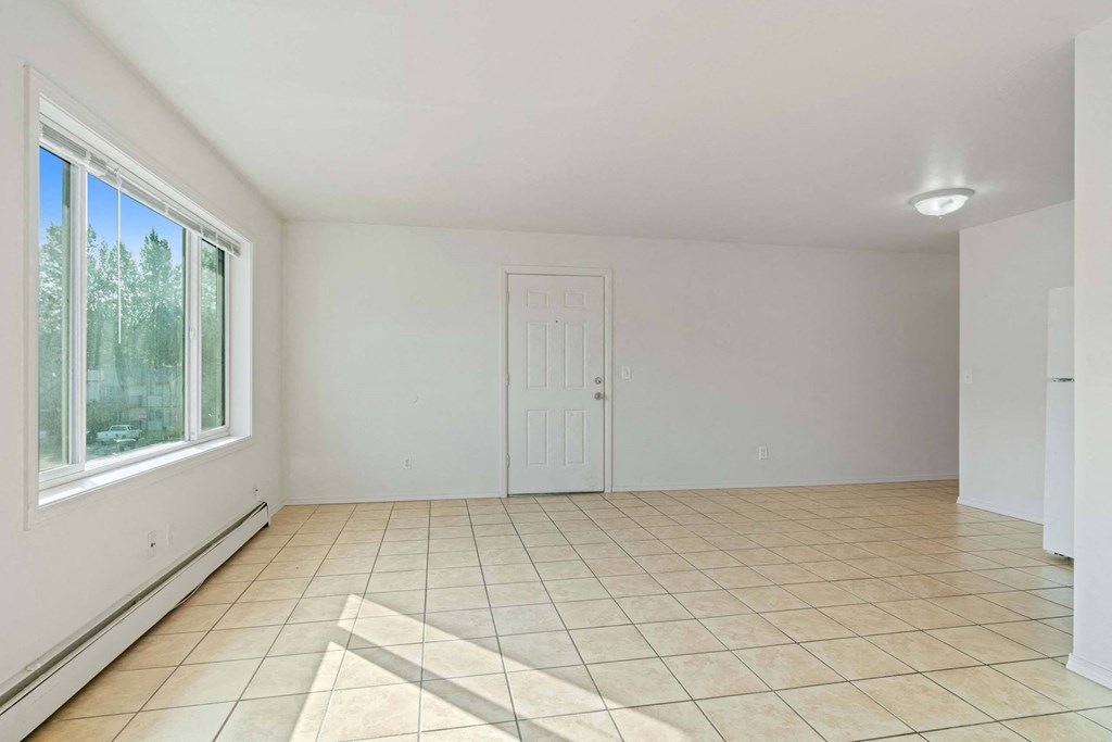 a bedroom with a large window and a tiled floor at ReNew Eagle River, Alaska, 99577