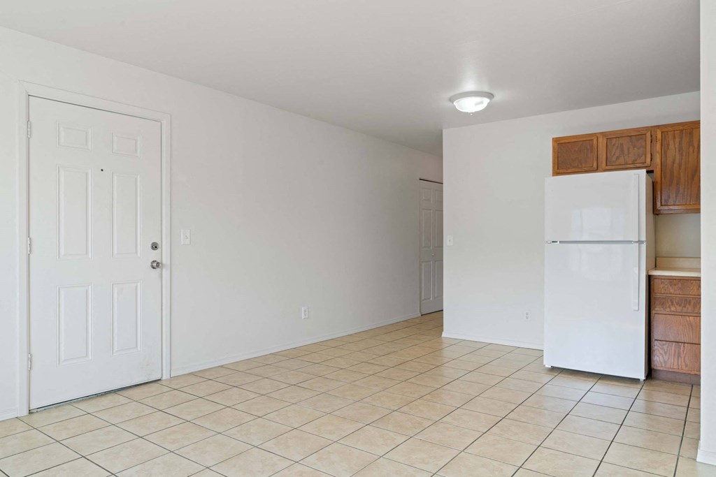 a kitchen with a white refrigerator freezer next to a doorway at ReNew Eagle River, Eagle River, AK, 99577