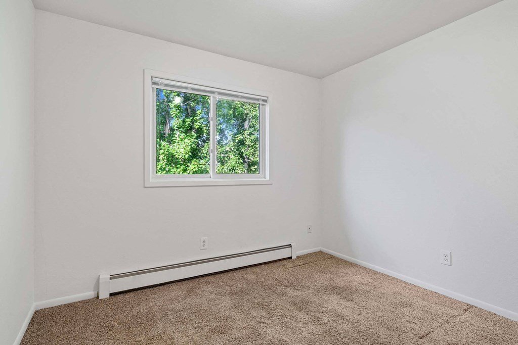 a bedroom with white walls and a window at ReNew Eagle River, Eagle River, AK