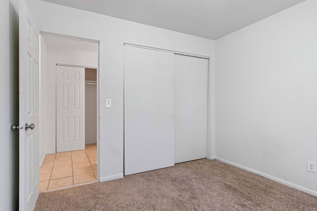 a bedroom with a large closet and a tiled floor at ReNew Eagle River, Eagle River, AK, 99577