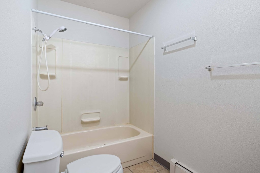 a bathroom with a toilet and a bathtub at ReNew Eagle River, Alaska, 99577