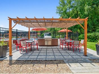 a patio with tables and chairs under a canopyat Renew Worcester, Worcester, MA