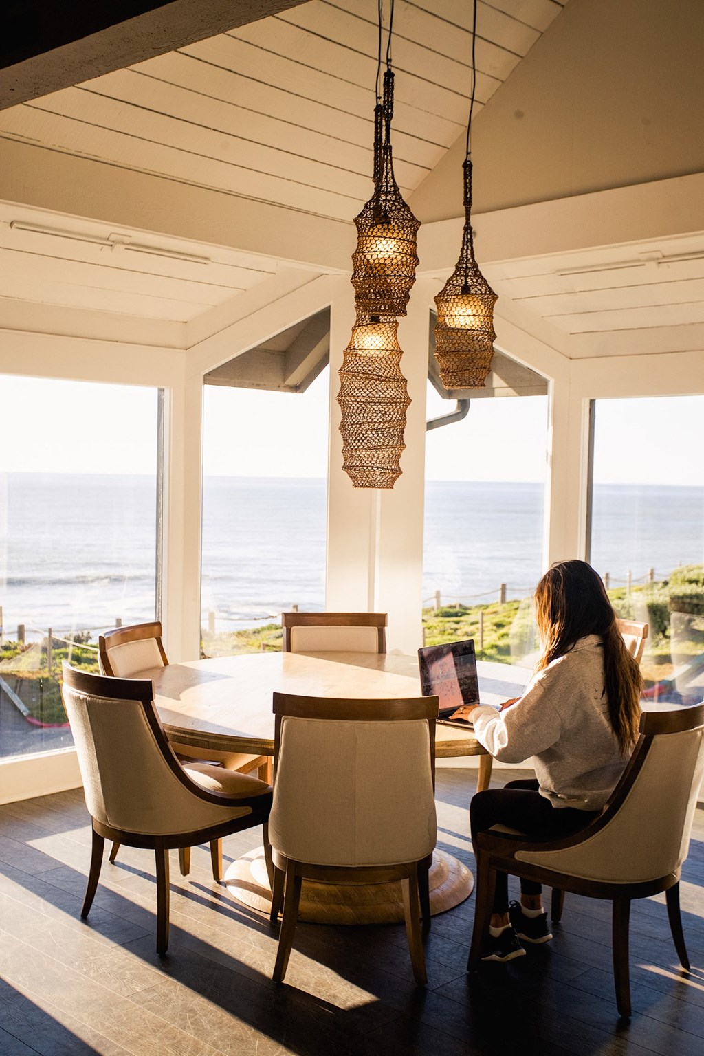 Woman working in the community room at Oceanaire