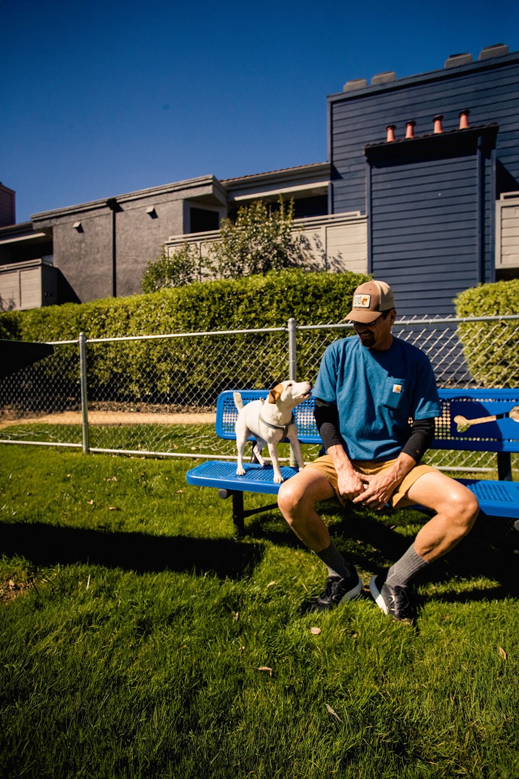 a man sitting on a bench with his dog