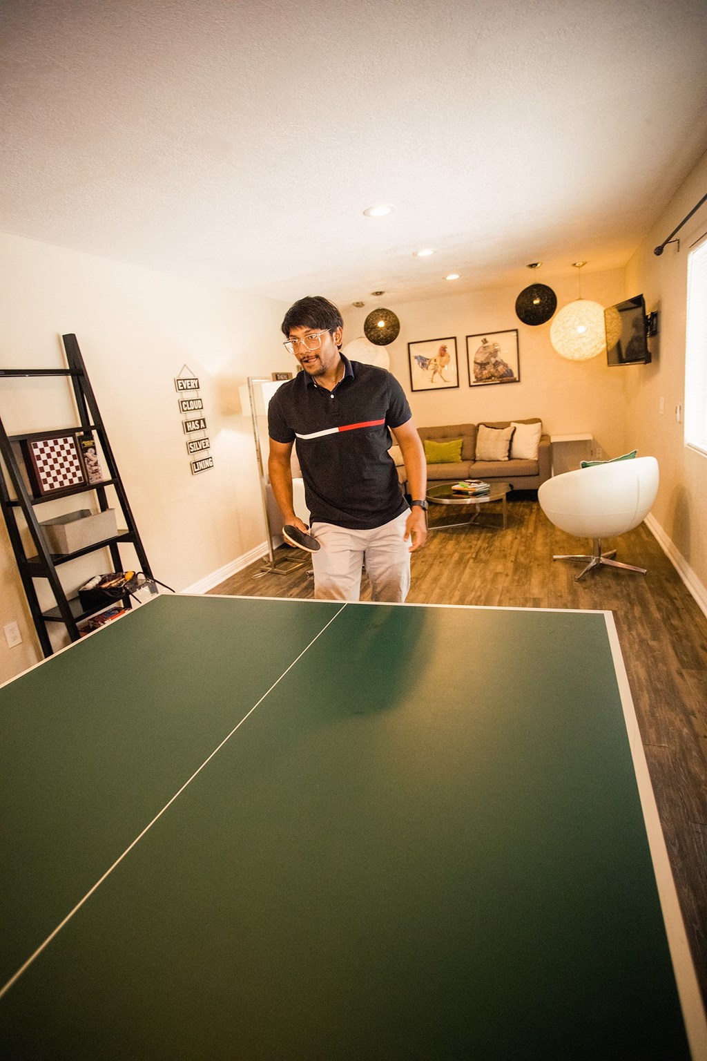 man playing ping pong at the clubhouse