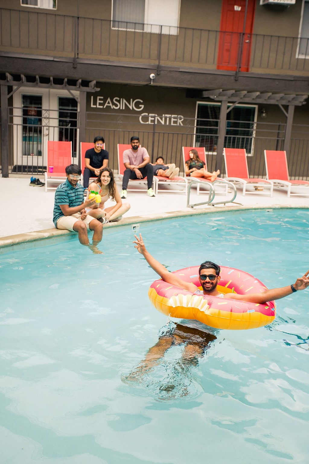 a man swimming in a pool with a floatie at Dwell