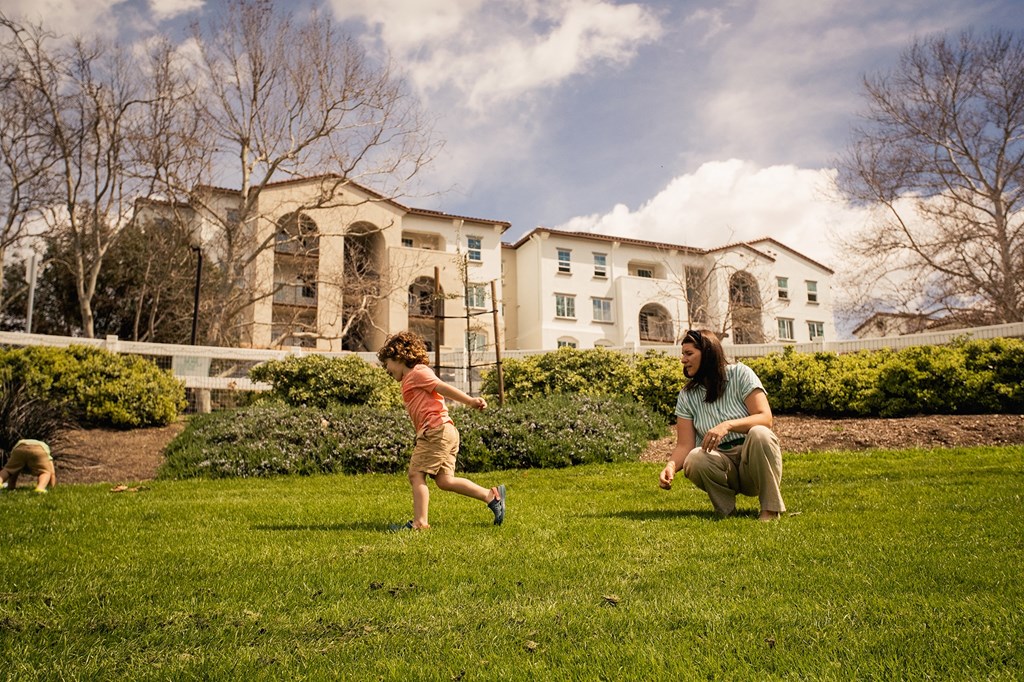 a woman playing with a child in a park at Arrive Temecula, California