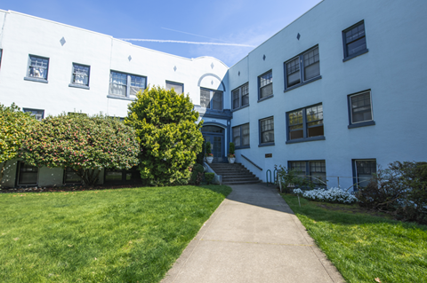 A white building with a blue door and windows.