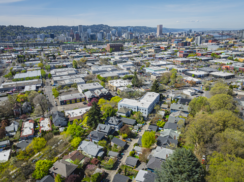 A cityscape with a mix of residential and commercial buildings.