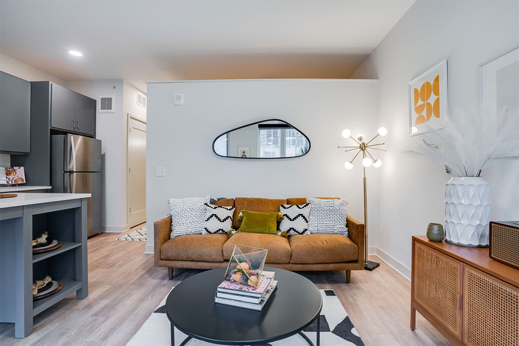 A living room with a brown couch and a black coffee table. at Sora Apartments, Minneapolis, Minnesota