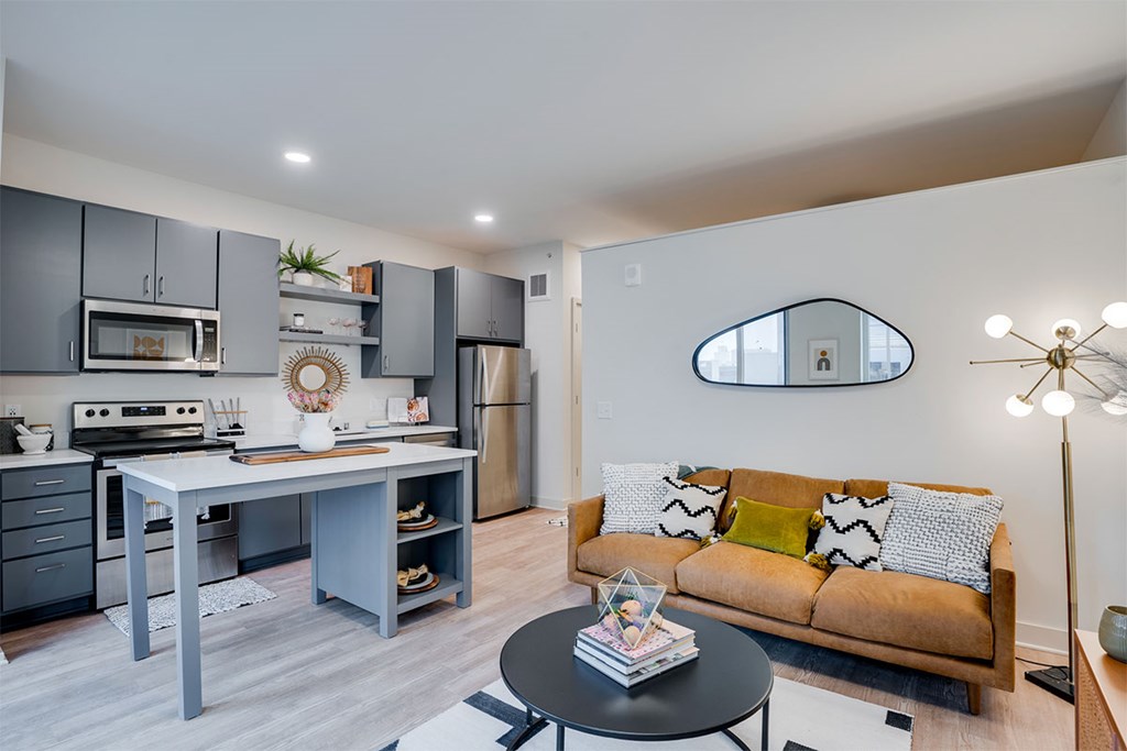 A modern kitchen with a dining table and a couch at Sora Apartments, Minneapolis, MN