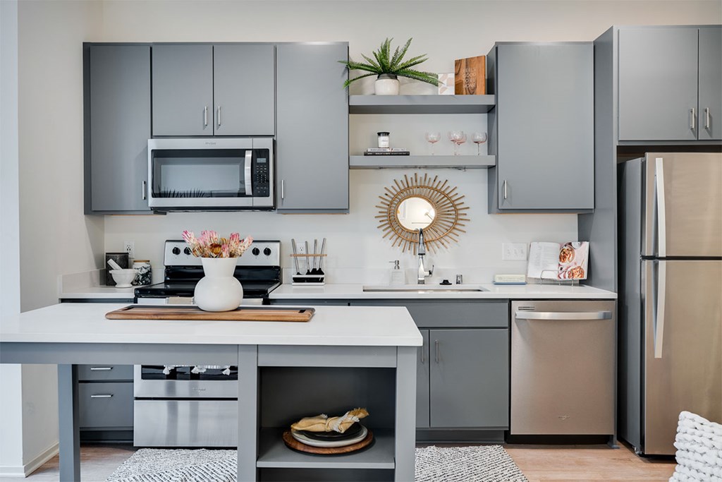 A modern kitchen with a grey cabinetry and stainless steel appliances at Sora Apartments, Minnesota, 55415