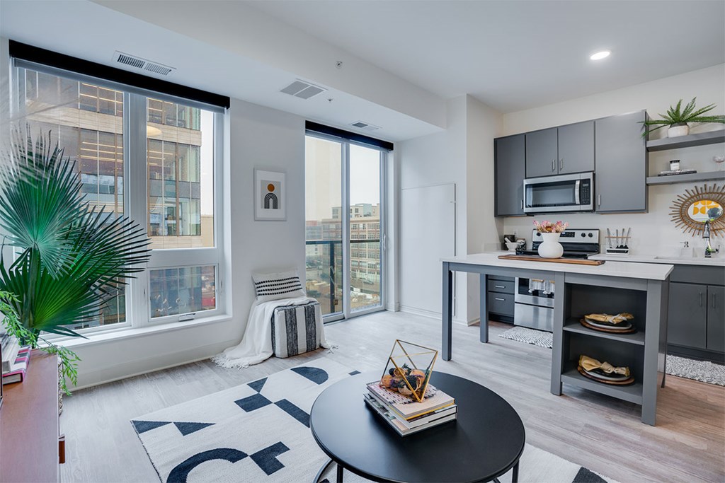 A modern kitchen with a black table and a framed picture on the wall. at Sora Apartments, Minneapolis, MN