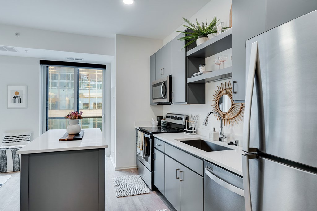 A modern kitchen with a refrigerator on the right side. at Sora Apartments, Minnesota