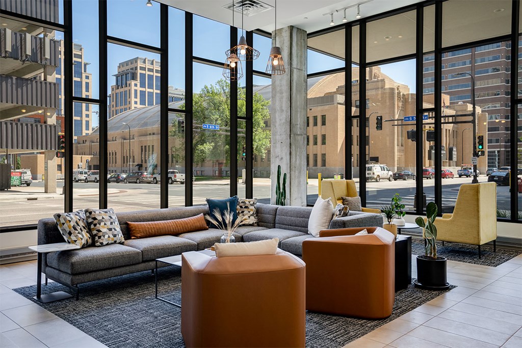 Lobby chairs with large windows in the background at Sora Apartments, Minneapolis, MN, 55415