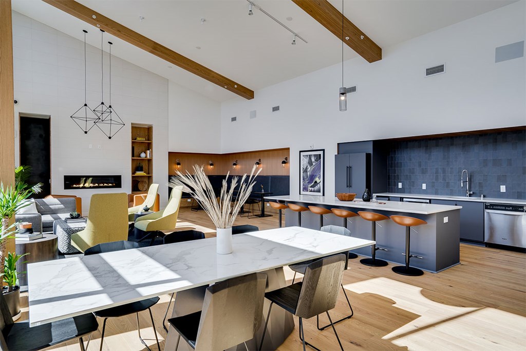 A modern kitchen with a dining table and chairs. at Sora Apartments, Minneapolis, Minnesota