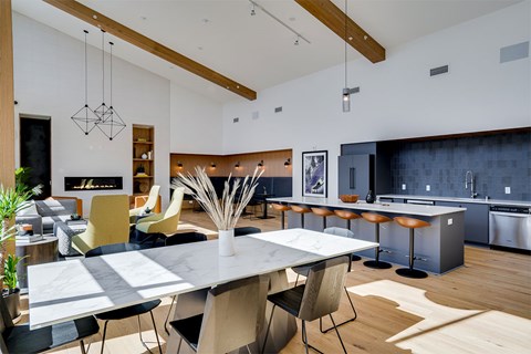 A modern kitchen with a dining table and chairs.