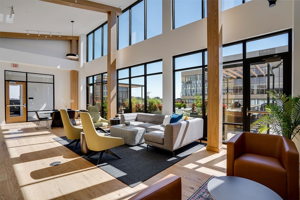 A modern lounge with a large window and a view of the city at Sora Apartments, Minneapolis, Minnesota