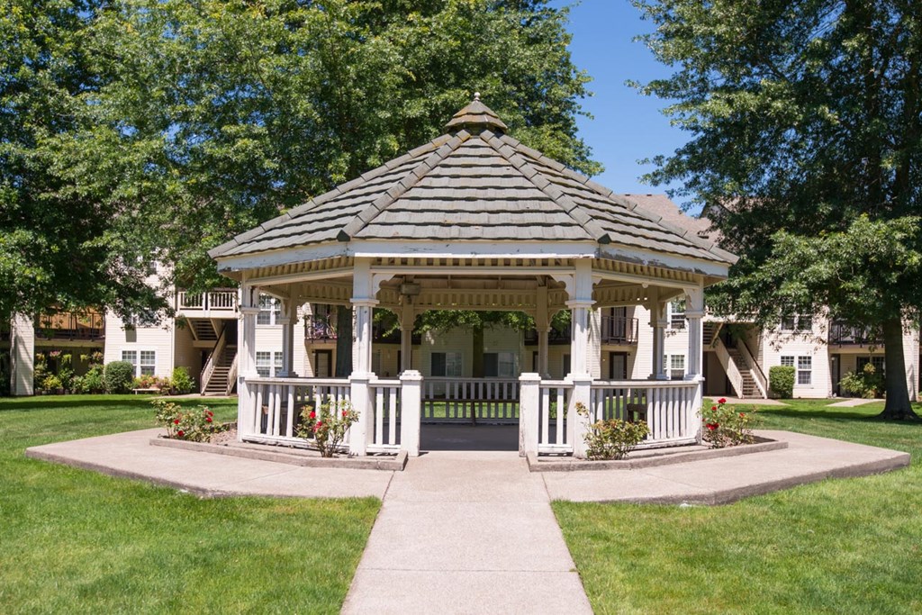 a gazebo in a yard in front of a house at Sundial Apartments, Wilsonville, OR