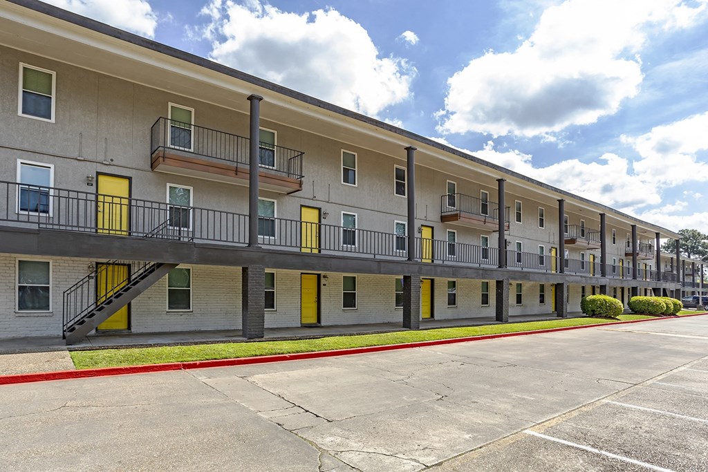 an exterior view of an apartment building with a parking lot at The Hub at Baton Rouge, Baton Rouge, 70808
