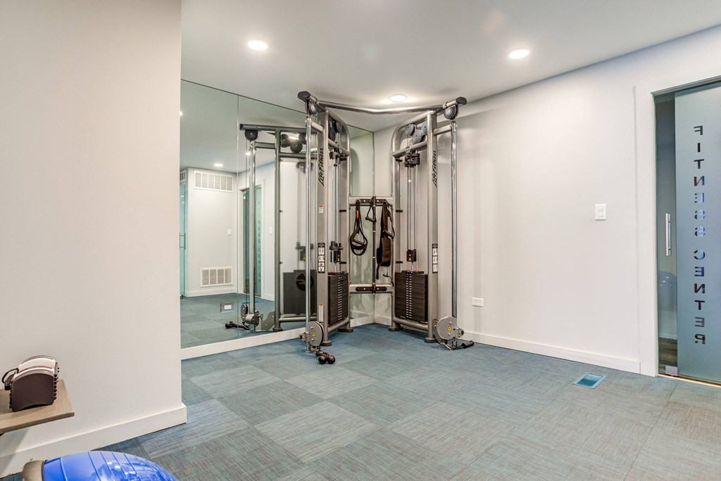 a home gym with a treadmill and exercise equipment at The Township at St. Charles, St. Charles