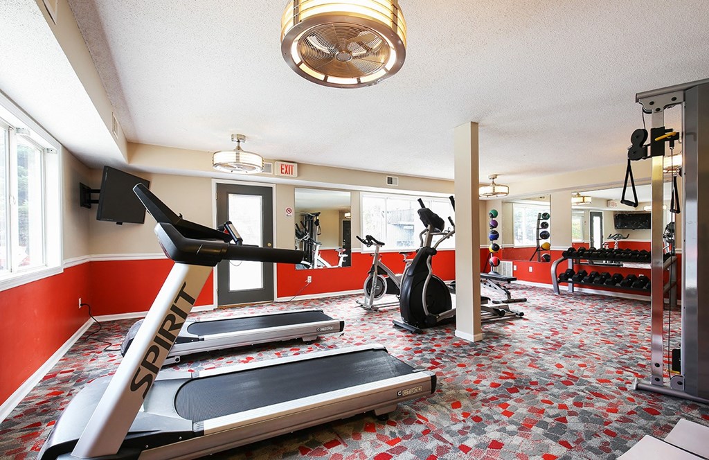 a gym with treadmills and other exercise equipment at the enclave at university crossings