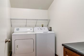 a washer and dryer in a laundry room with a sink and a counter