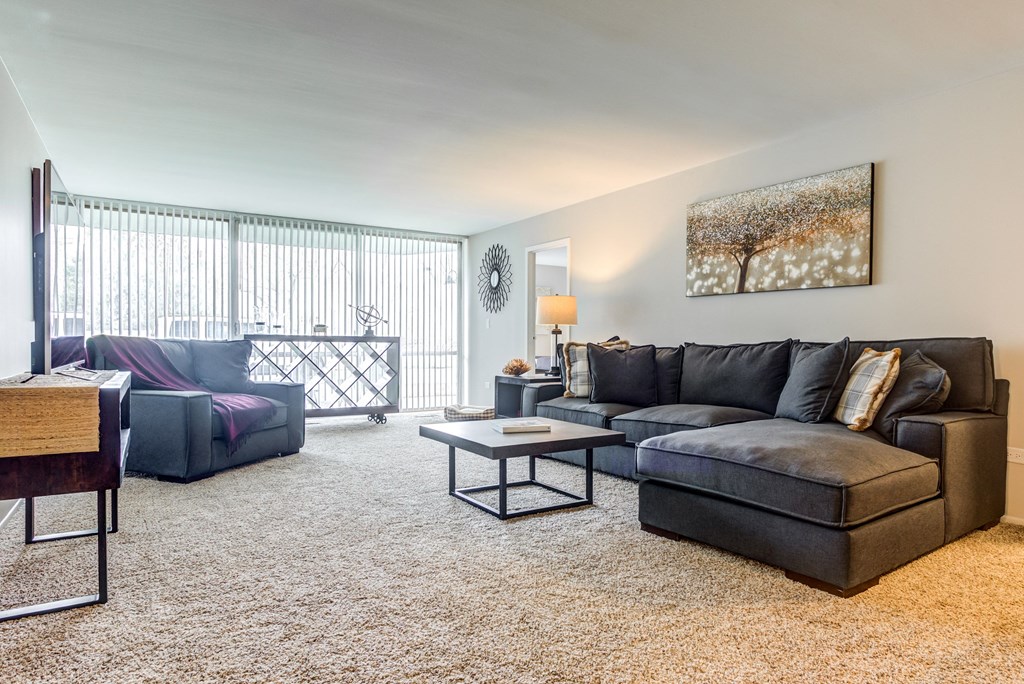 a living room with a couch and a chair at The Township at St. Charles, St. Charles, IL
