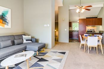 a living room and dining room with a couch and a table