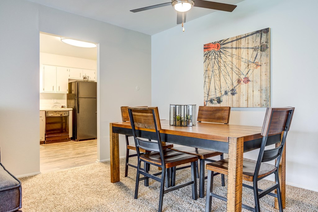 a dining room table with four chairs and a ceiling fan at The Township at St. Charles, Illinois