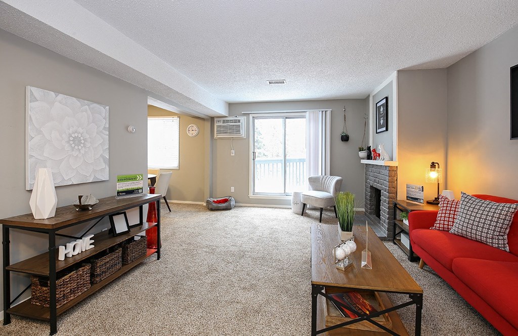 a living room with a red couch and a table