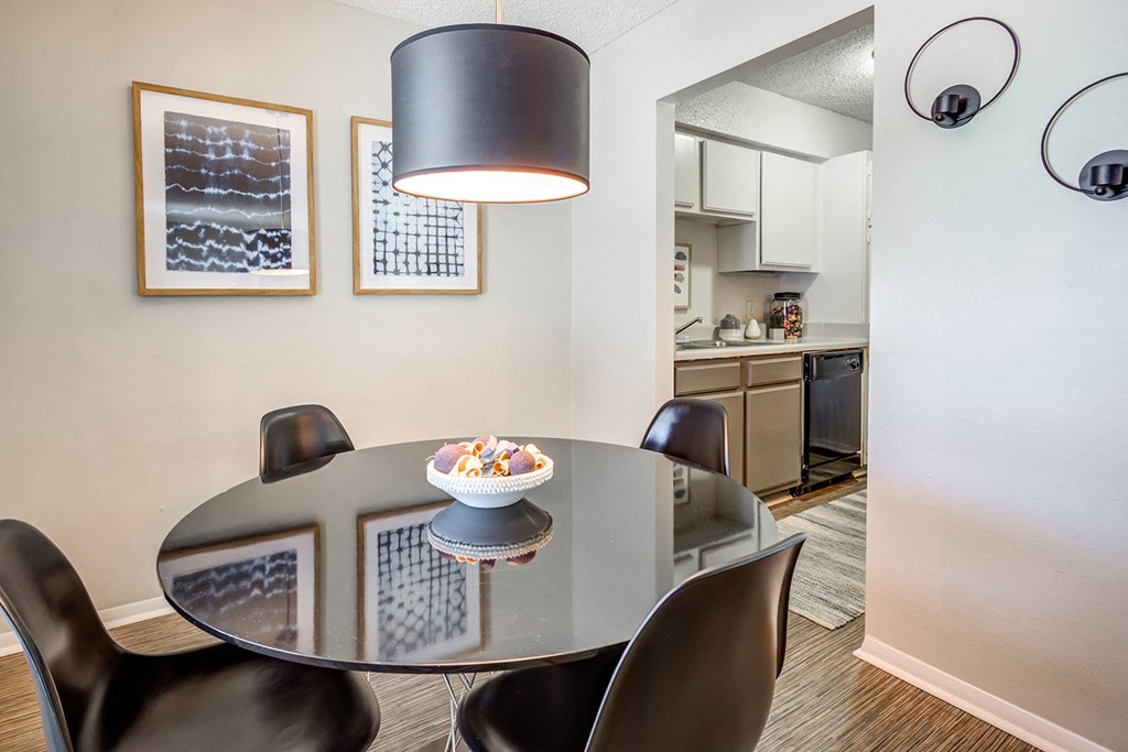 a dining room with a table and chairs and a kitchen at The Hub at Baton Rouge, Louisiana