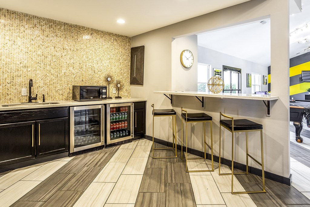 a kitchen with a counter with three stools at The Hub at Baton Rouge, Baton Rouge, LA 70808