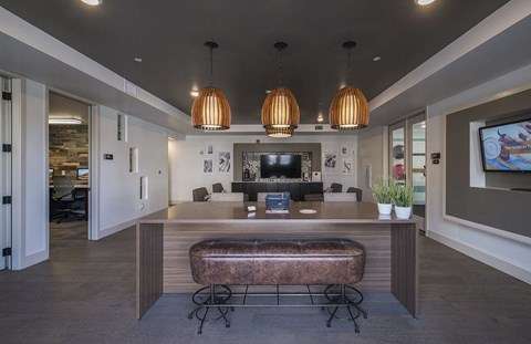 a kitchen with a bar and a living room with a tv