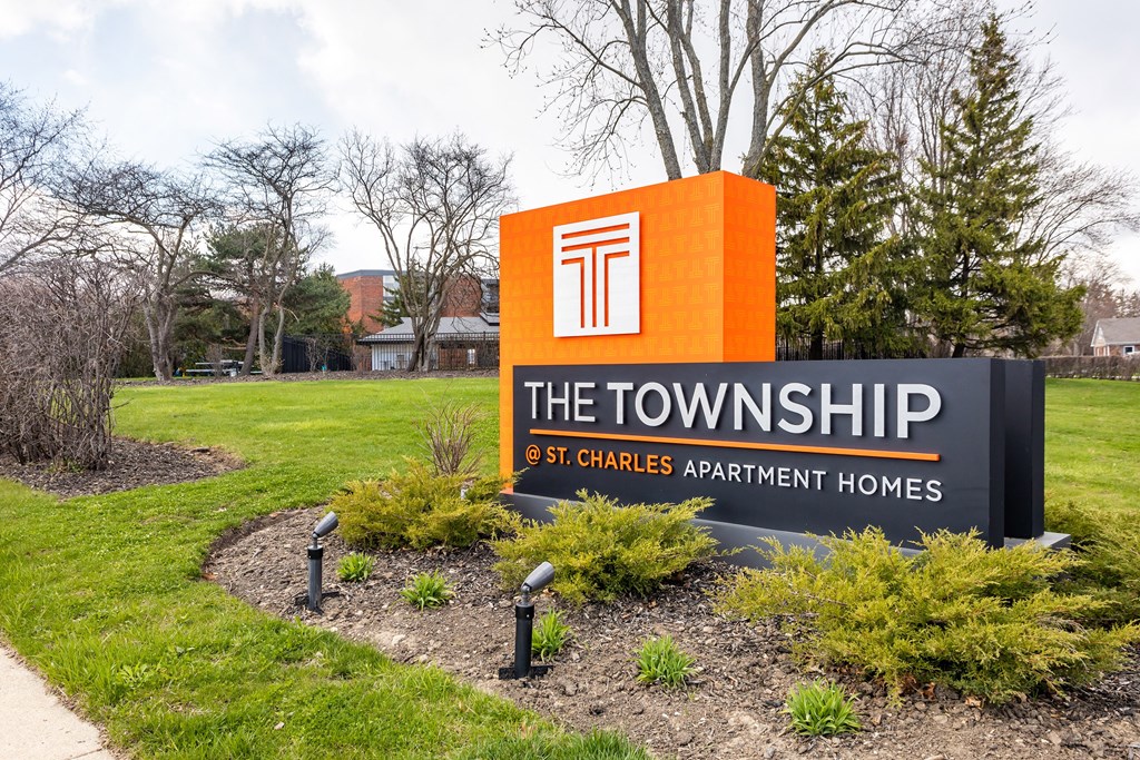 a sign that says the townships at the entrance to a lawn with trees in the backgroundat The Township at St. Charles, St. Charles, Illinois
