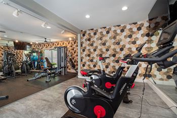 a gym with exercise equipment and a wall of tiles  at Ascent at Farmington Hills, Farmington Hills, 48331