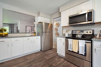 a kitchen with stainless steel appliances and white cabinets  at Ascent at Farmington Hills, Farmington Hills, MI