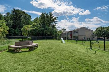 a backyard with a picnic table and a chain link fence  at Ascent at Farmington Hills, Farmington Hills, MI