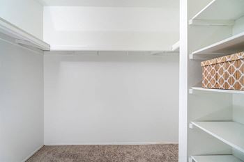 a walk in closet with white walls and shelves  at Ascent at Farmington Hills, Farmington Hills