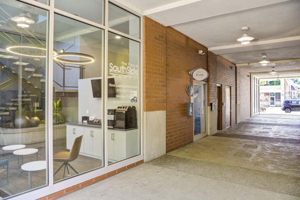 a building with a counter and chairs in front of it at Flats at Southside, Pennsylvania, 15203