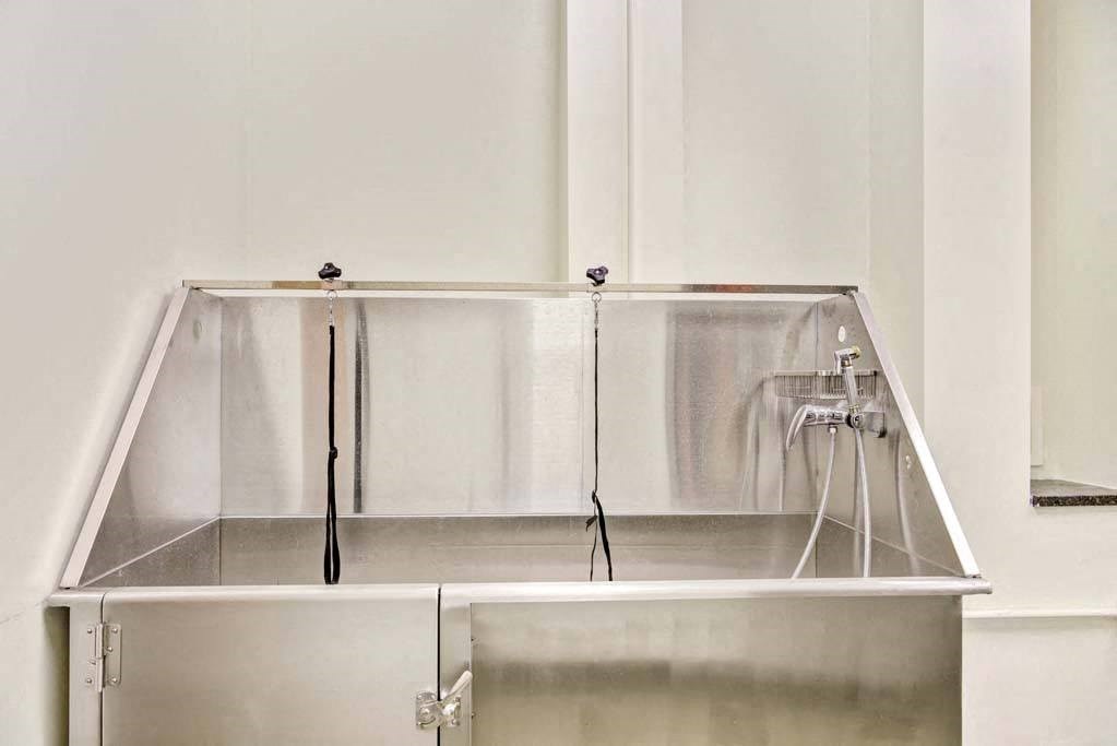 a large stainless steel tub sitting for pet washing next to a wall at Flats at Southside, Pittsburgh, 15203