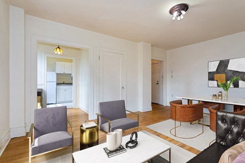 A living room with a white table and chairs.