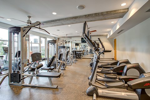 Gym with treadmills, weights, and exercise equipment at Track 29 Apartments, Minneapolis, MN, 55408