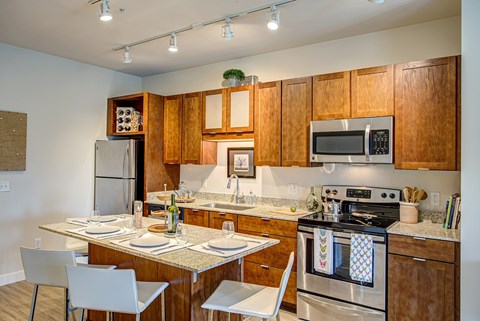 Kitchen with wooden cabinets and a stove top oven at Track 29 Apartments, Minneapolis, MN