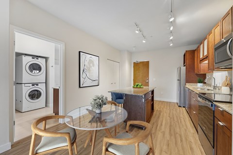 A modern kitchen with a glass table and chairs.