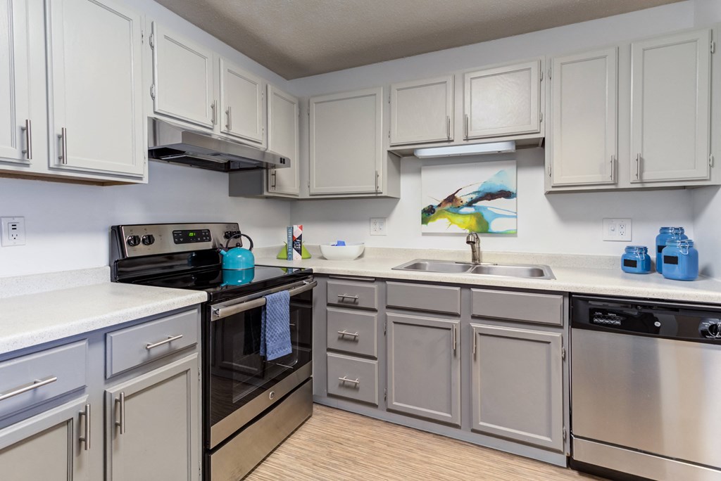 a kitchen with white cabinets and a black stove top oven