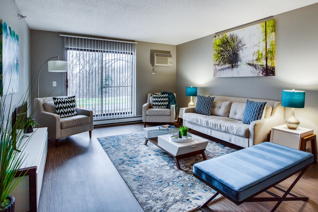 our apartments offer a living room with a couch coffee table and chairs