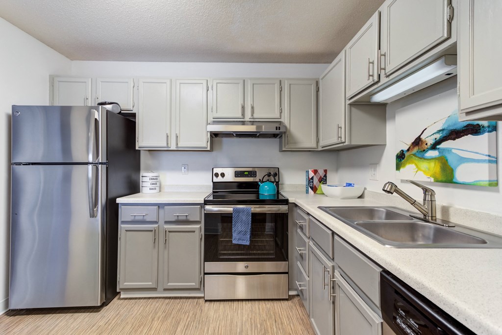 a kitchen with white cabinets and stainless steel appliances