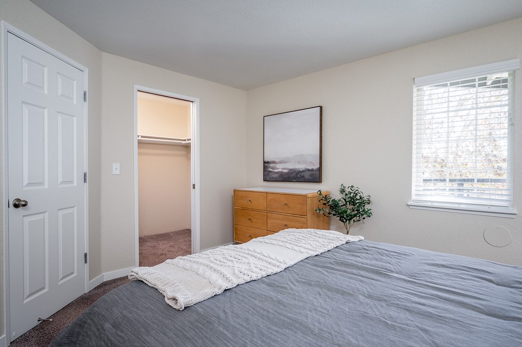 an empty bedroom with a bed and a closet at Sundial Apartments, Oregon, 97070